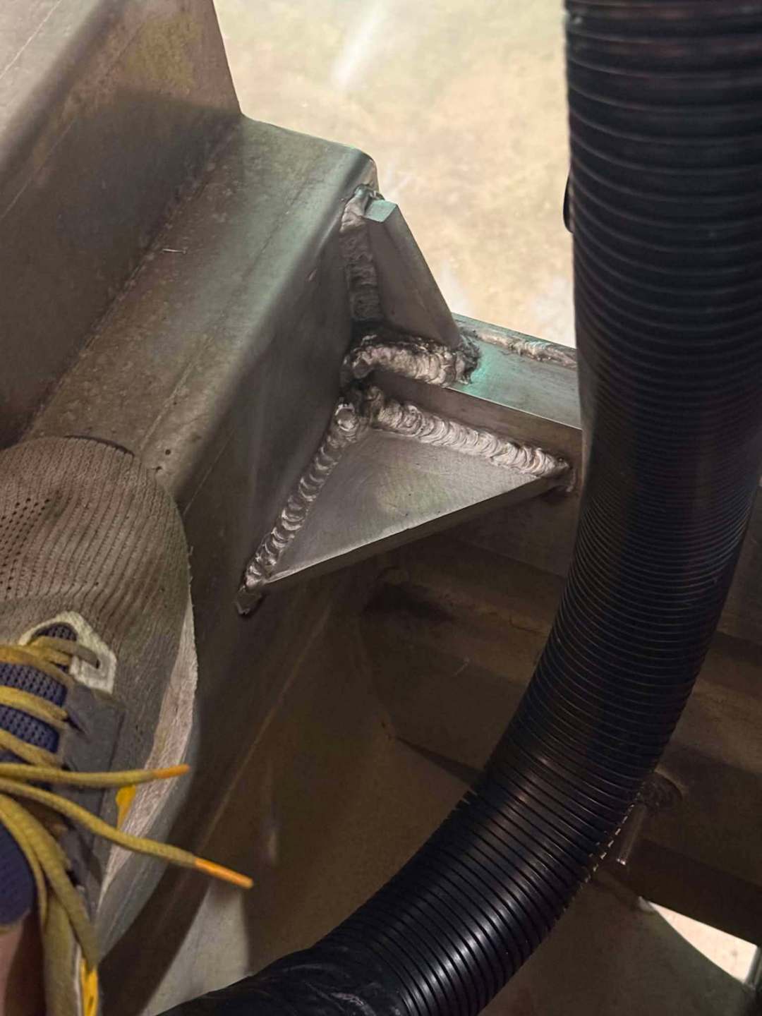 Steel gusset welded into a trailer frame corner joint at JG's Custom Fabrication in Bunkie, Louisiana