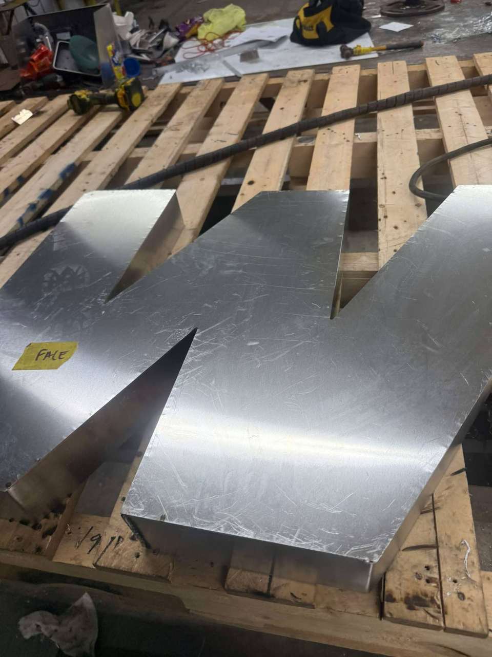 Brushed aluminum sign letter W fabricated in Bunkie, Louisiana