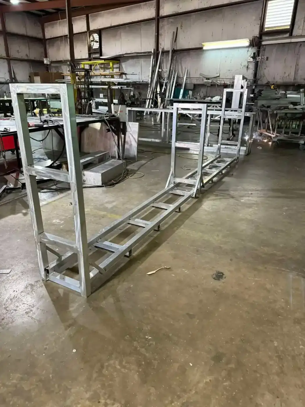 Long welded aluminum sign support frame standing on the shop floor during fabrication in Bunkie, Louisiana