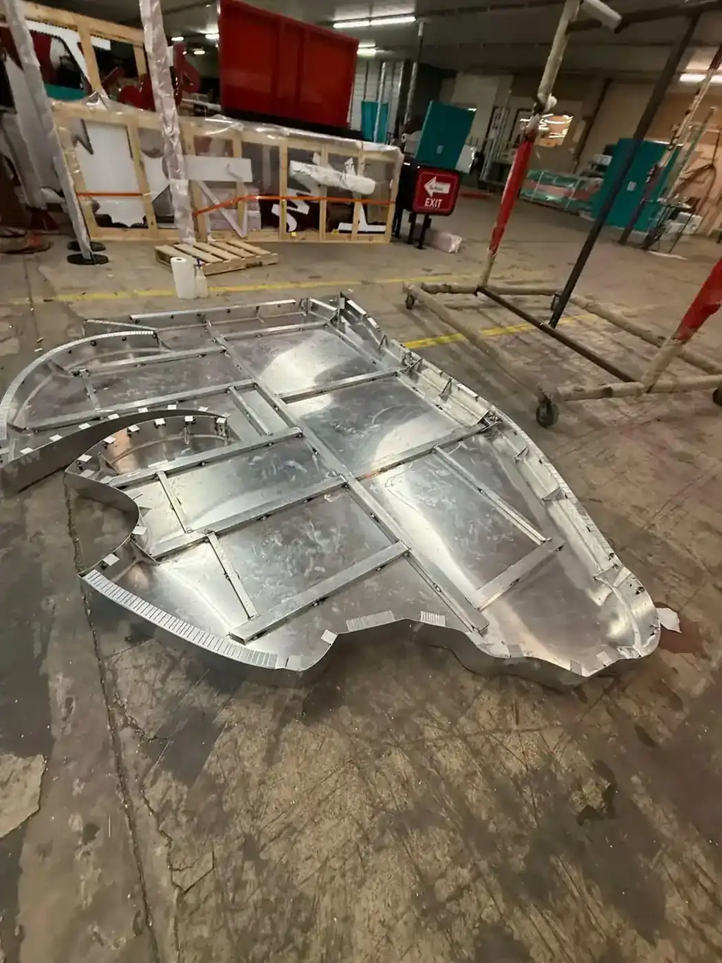 Oversized aluminum logo sign pan under assembly with framed backing and curved returns in the Bunkie shop