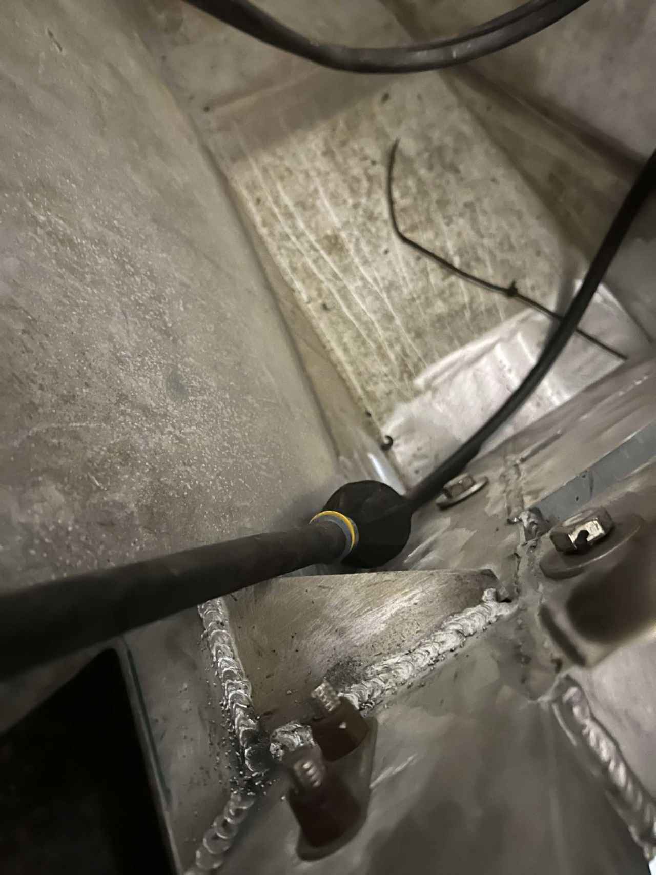 Aluminum welding inside an aluminum boat hull with wiring routed through the interior at JG's shop in Bunkie, Louisiana