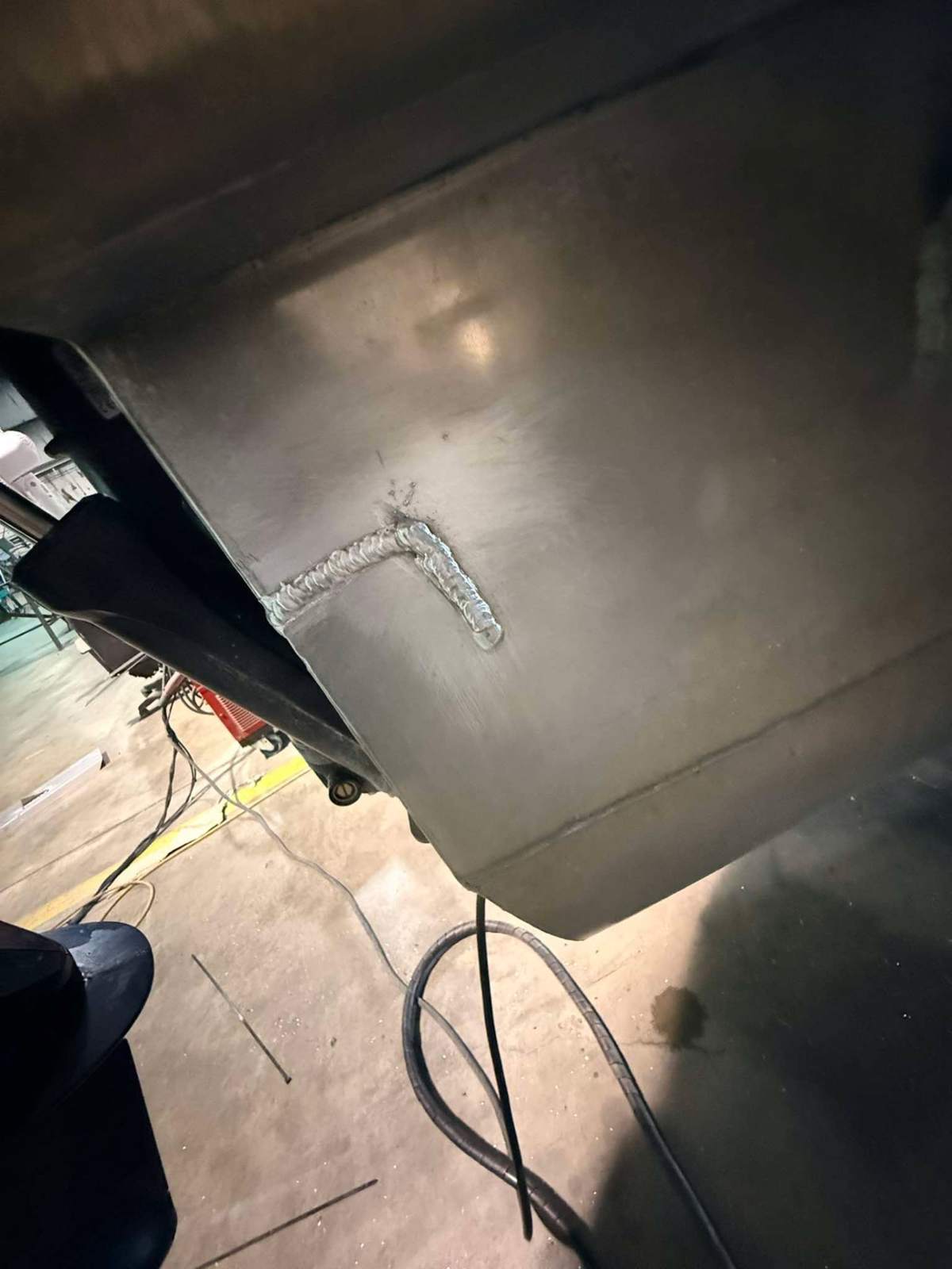 Welded support bracket on the underside of a fabricated metal box in Bunkie, Louisiana