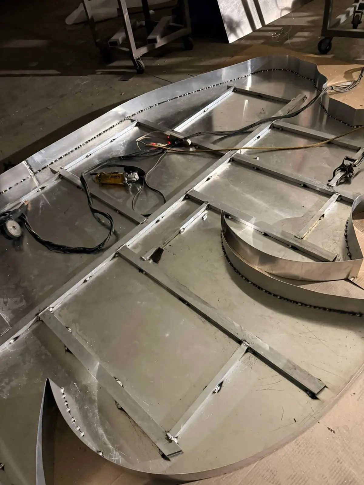 Close view of internal aluminum bracing and stitch welds inside a large channel letter sign pan